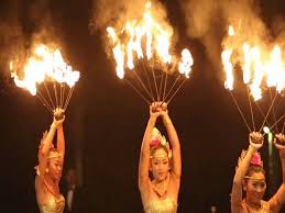 Fire-walking ceremony with dancer stepping through flames